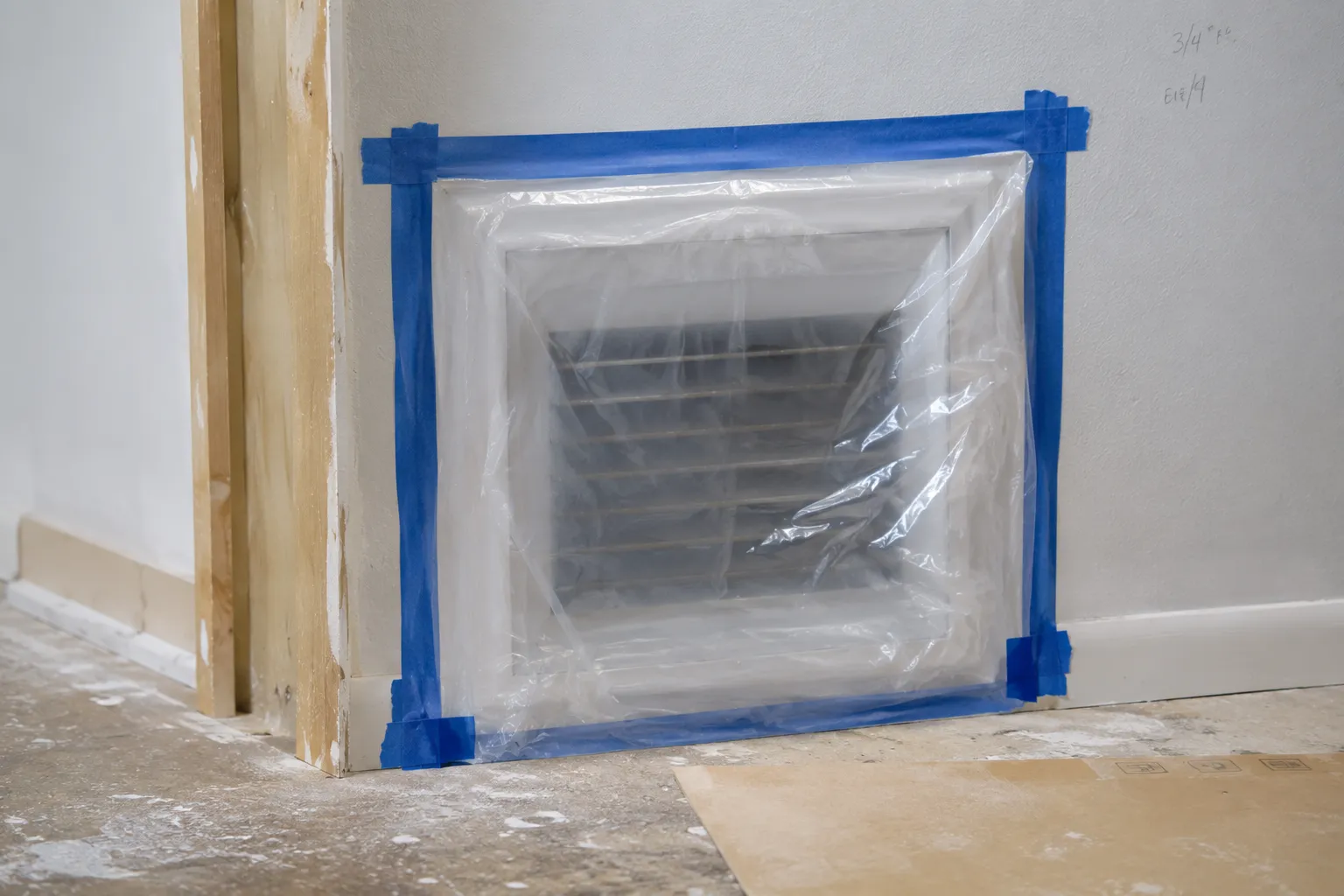 Return air vent sealed with plastic sheeting and painter's tape during home renovation