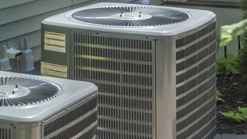 Commercial HVAC condenser units outside an office building connected to the building's air distribution system.